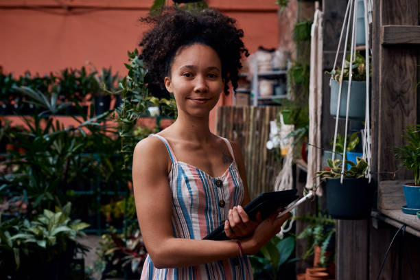 istock Portrait of a young woman using a digital tablet while working in a garden centre 1317794767