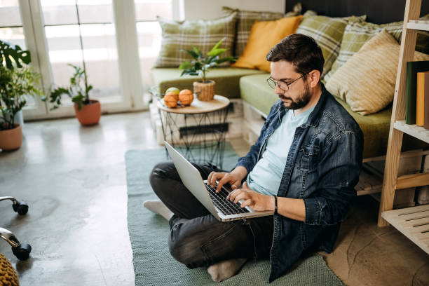 istock Caucasian man working on the floor with a laptop and documents 1317795160