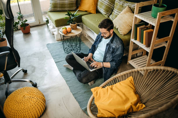 istock Caucasian man working on the floor with a laptop and documents 1317795480