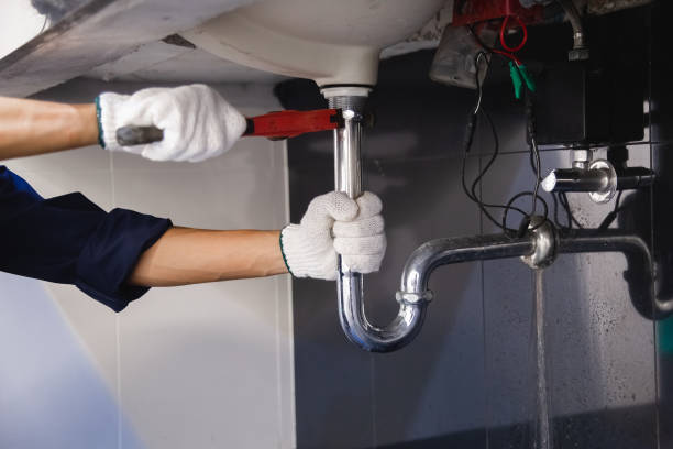 istock Plumber fixing white sink pipe with adjustable wrench. 1317795578
