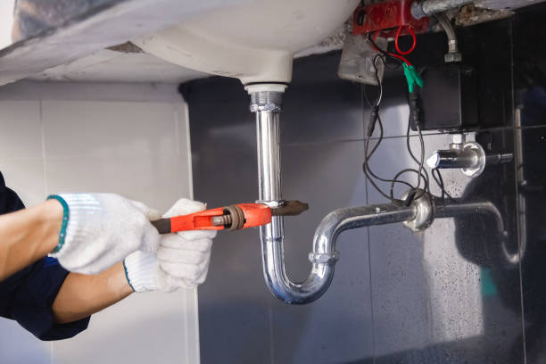 istock Plumber fixing white sink pipe with adjustable wrench. 1317795595