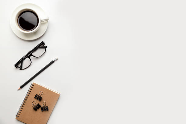 istock Flat lay, top view office table desk. Workspace with blank Laptop, office supplies , pencil, green leaf, and coffee cup on white background. 1317795607