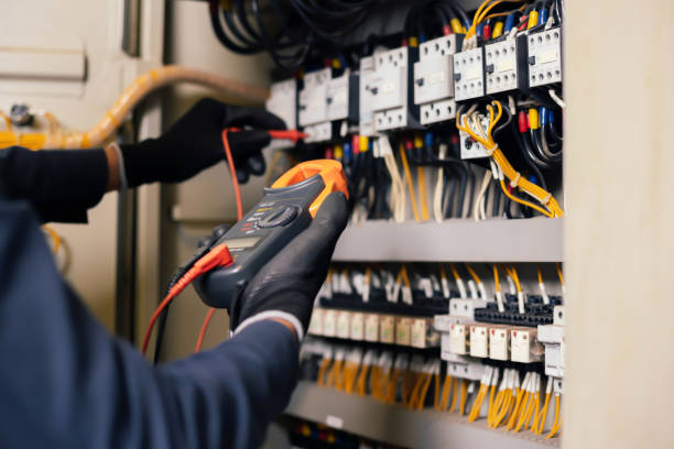 istock Electrician engineer work tester measuring voltage and current of power electric line in electrical  cabinet control. and wires on relay protection system. 1317795663