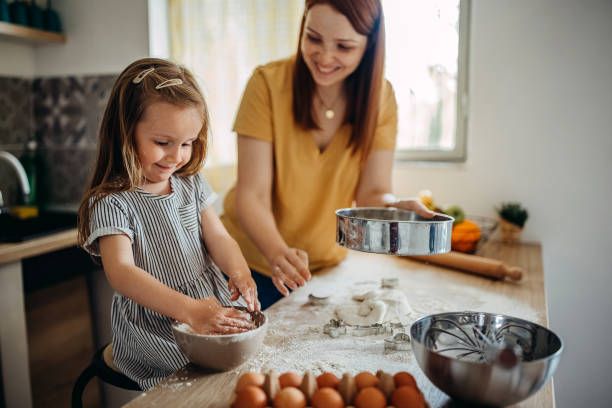 istock Mom and daughter prepare pastries in the kitchen. 1317797321