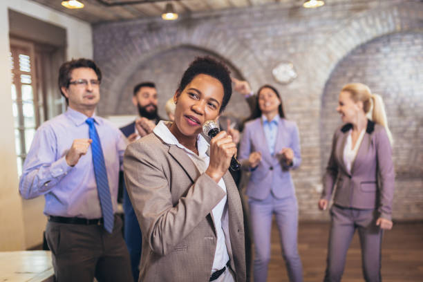 istock Business people having karaoke party at co-working space 1317798480