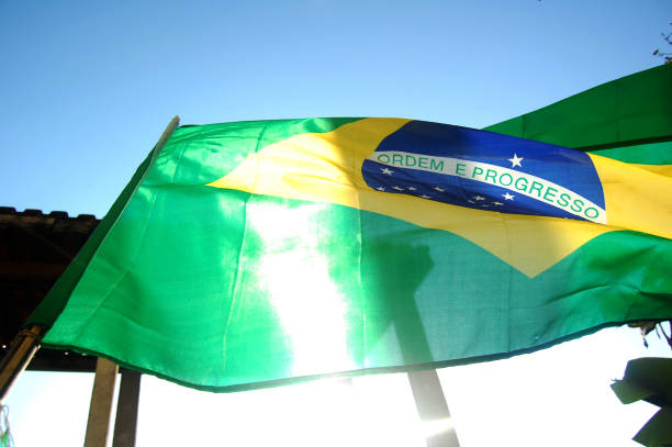 istock Brazilian flag in blue sky. 1317798541