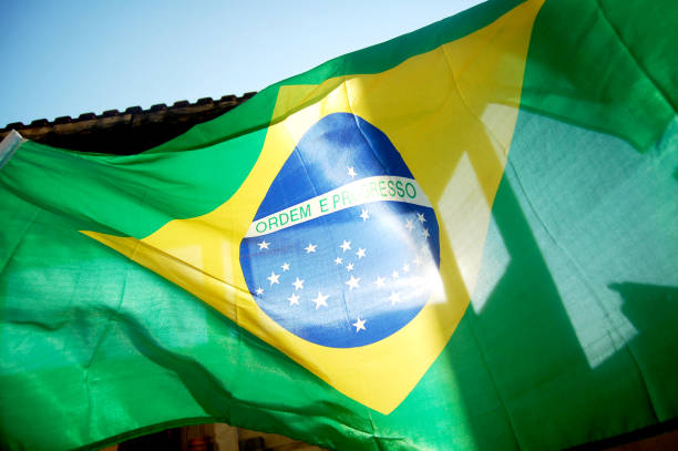 istock Brazilian flag in blue sky. 1317798559