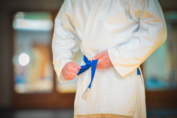 istock Male fighter tightening karate belt 1317800429
