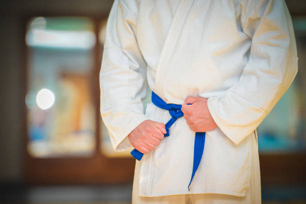 istock Male fighter tightening karate belt 1317800436