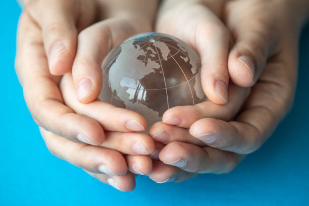 istock Mother And Her Daughter Are Holding A Glass Globe 1317801028