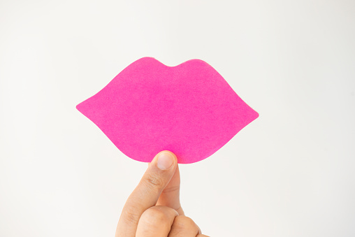 Pink post-it notes in the shape of lips.