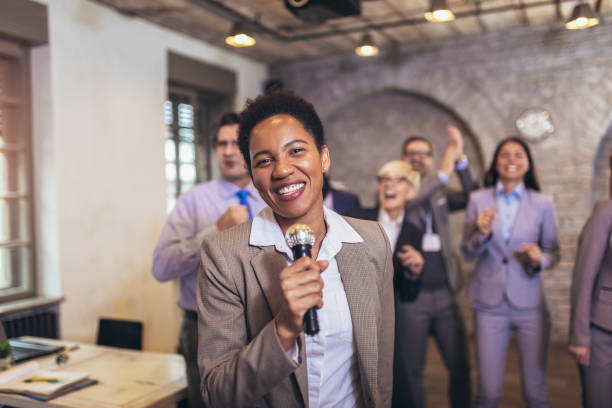 istock Business people having karaoke party at co-working space 1317802017