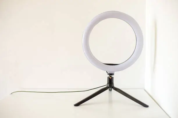 Photo of New ring lamp on tripod on white table