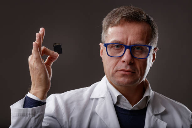 istock Scientist or forensics expert holding up an SD Card 1317803402