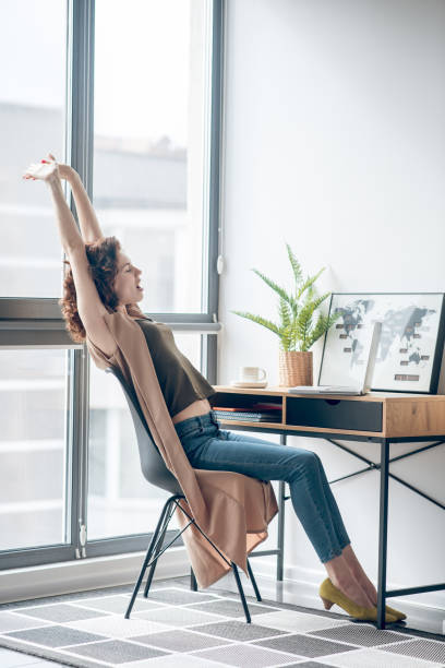 istock Dark-haired woman sitting with telephone in hands 1317803584