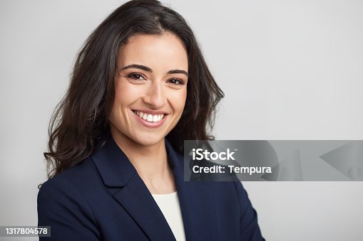 istock One businesswoman headshot smiling at the camera. 1317804578