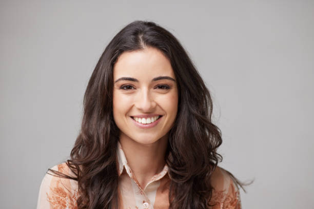 istock One woman smiling and looking at the camera. 1317804609