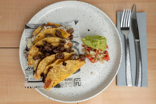 istock Tacos, Mexican food from above on madrera background 1317805011