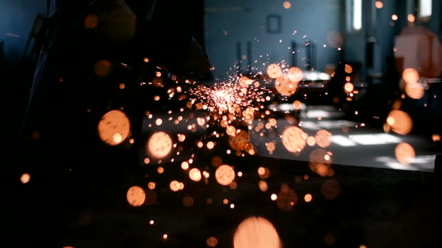 worker using an angle grinder producing a lot of sparks