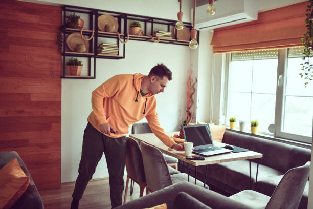 istock Modern Male Preparing His Workspace At Home With Coffee Before Starting Freelance Work 1317808171