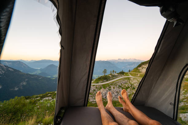couple camping in mountains in their rooftop tent