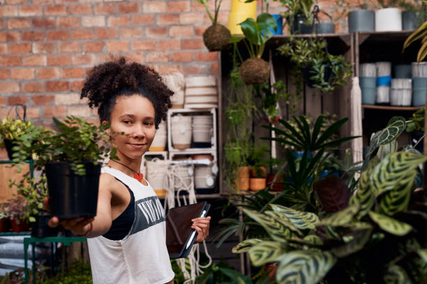 istock Shot of a young woman using a digital tablet while working in a garden centre 1317809927