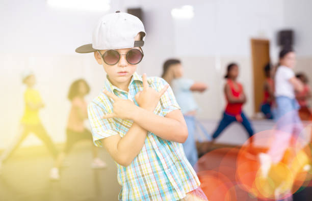 istock Preteen boy training hip-hop during group dance lesson 1317812095