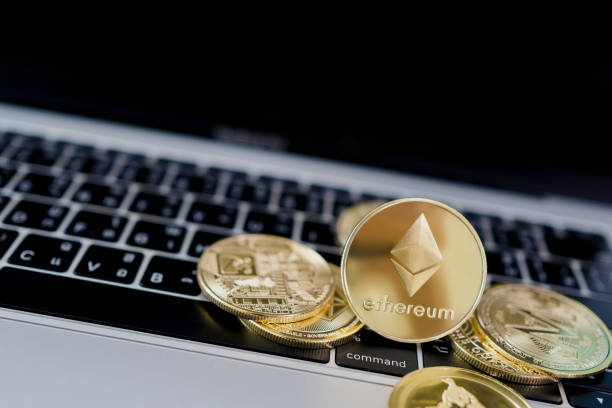 Virtual cryptocurrency concept. Golden Ethereum on the laptop touchpad closeup. Virtual cryptocurrency concept. Golden Ethereum on the laptop touchpad closeup. litecoin stock pictures, royalty-free photos & images