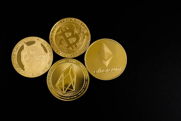 Top view of Bitcoin, Ethereum, EOS and Dogecoin coins on a black background. Top view of Bitcoin, Ethereum, EOS and Dogecoin coins on a black background. ethereum stock pictures, royalty-free photos & images