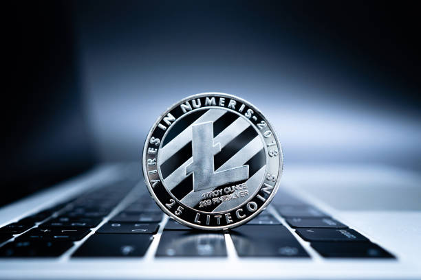 Close up of silver coin Litecoin on laptop computer keyboard. Close up of silver coin Litecoin on laptop computer keyboard. litecoin stock pictures, royalty-free photos & images