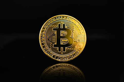 Bitcoin coins on a black background.
