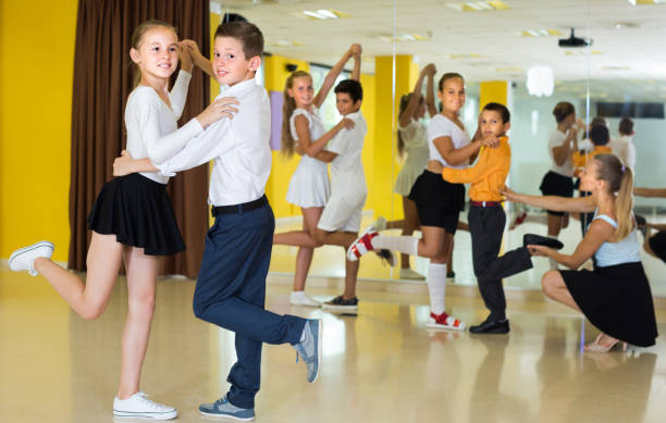 istock Smiling children are dancing waltz 1317813083