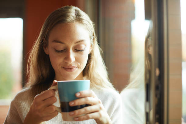 istock A woman relaxing and looking at her tea at home. 1317814604