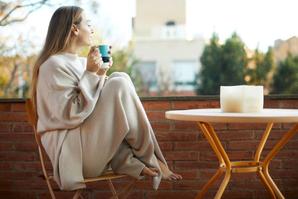 istock A woman relaxing and drinking coffee in her backyard. 1317814634