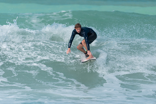 January 24th 2021, Dubai UAE, A surfers on Sunset Beach in Dubai riding his board on the big waves