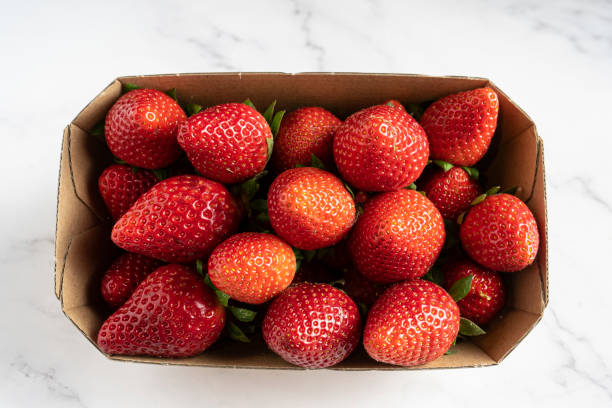 strawberry box isolated on white marble background