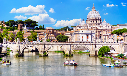 St. Peter's Basilica in Vatican and Tiber river in Rome at sunny day