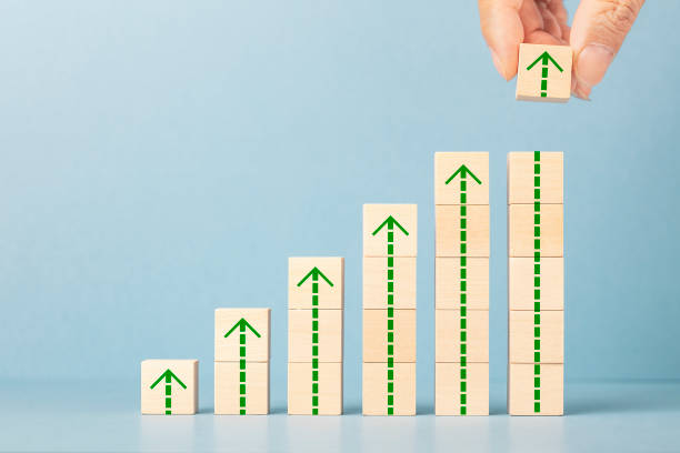 Business success growing growth increase up concept. Business success growing growth increase up concept. Hand arranging wood block stacking as step stair with arrow up. growth in sales stock pictures, royalty-free photos & images