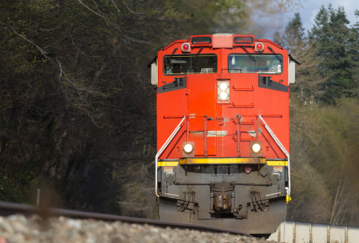 British Columbia, Canada - April 30 2021 : Canadian National Railway freight train traveling on rural area.