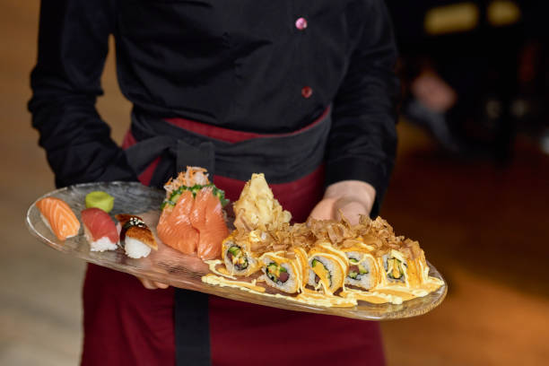 istock Delicious fresh sushi being served by a waitress 1317818270