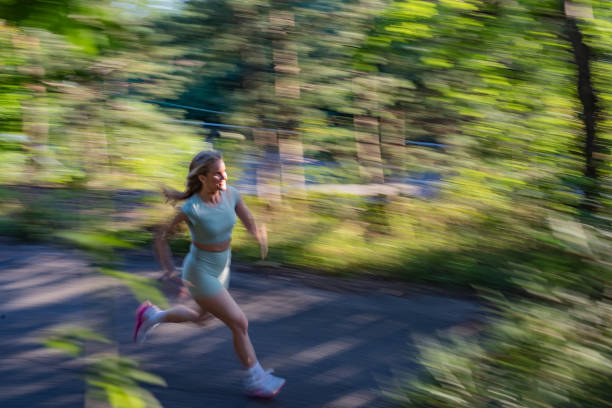 istock Young sporty woman jogging through the forest 1317819076
