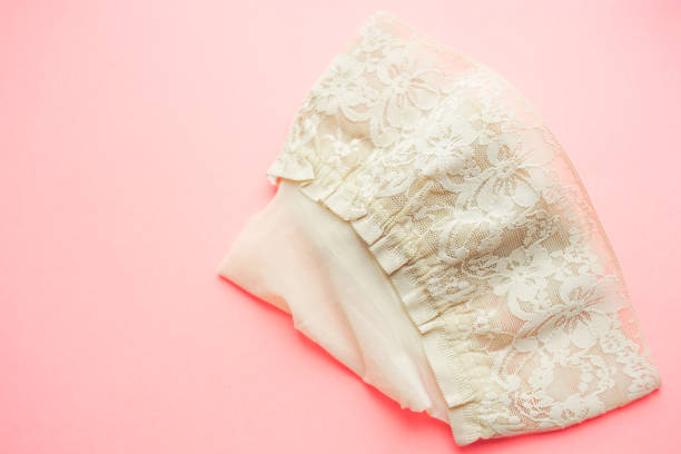 istock Beige stockings with elastic lace on the pink table 1317819624
