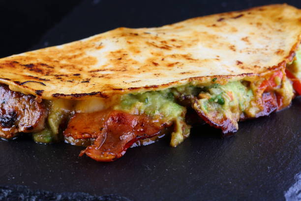 Quesadilla with white and red sauce stock photo