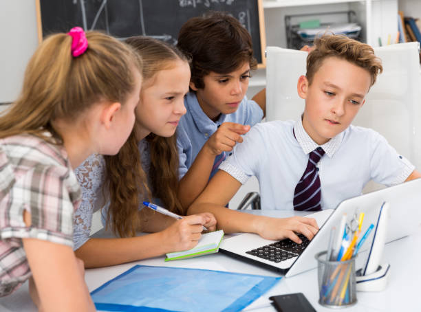 istock children near laptop talking about mathematics 1317825523