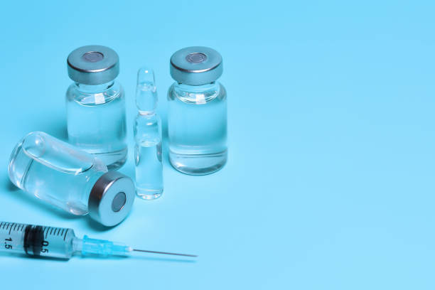 istock Medicine vials and syringe. Vaccination, Immunization. Fighting the coronavirus pandemic, treating pain, cancer and other diseases. Copy space 1317828254