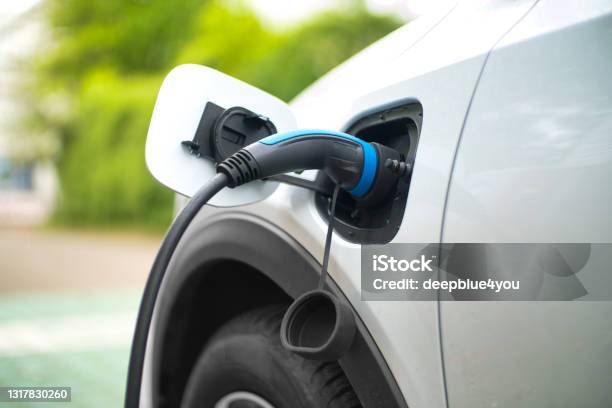 Electric Car Charging At Power Station Stock Photo - Download Image Now - Electric Car, Electric Vehicle, Charging