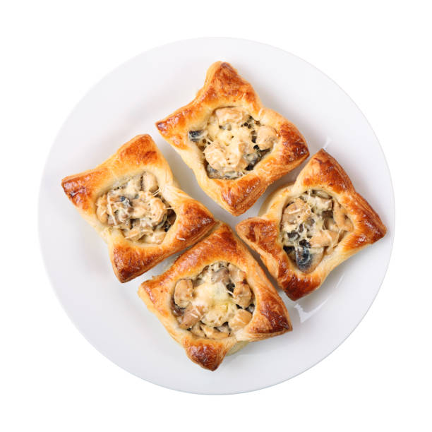 Julien in puff pastry baskets top view four edible puff pastry baskets with Julien on a white round dish isolated over white background. top view. unusual basket stock pictures, royalty-free photos & images
