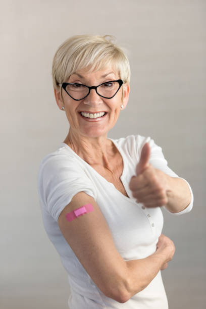 istock Portrait of a beautiful elderly lady just got vaccinated, showing a patch 1317839362