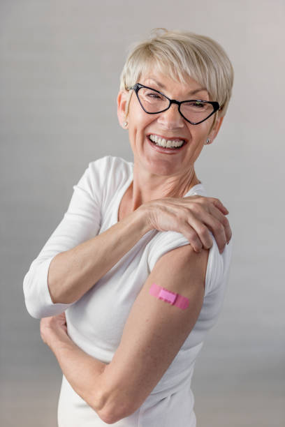 istock Portrait of a beautiful elderly lady just got vaccinated, showing a patch 1317839372