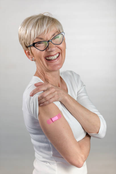 istock Portrait of a beautiful elderly lady just got vaccinated, showing a patch 1317839513